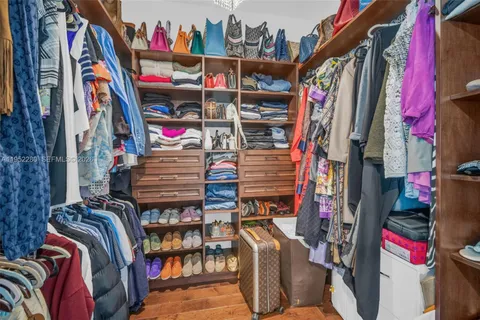 a living room with furniture and floor to ceiling windows