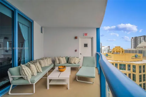 a view of a chair and tables in the balcony