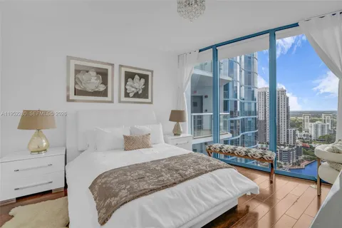 a view of a house with swimming pool and sitting area