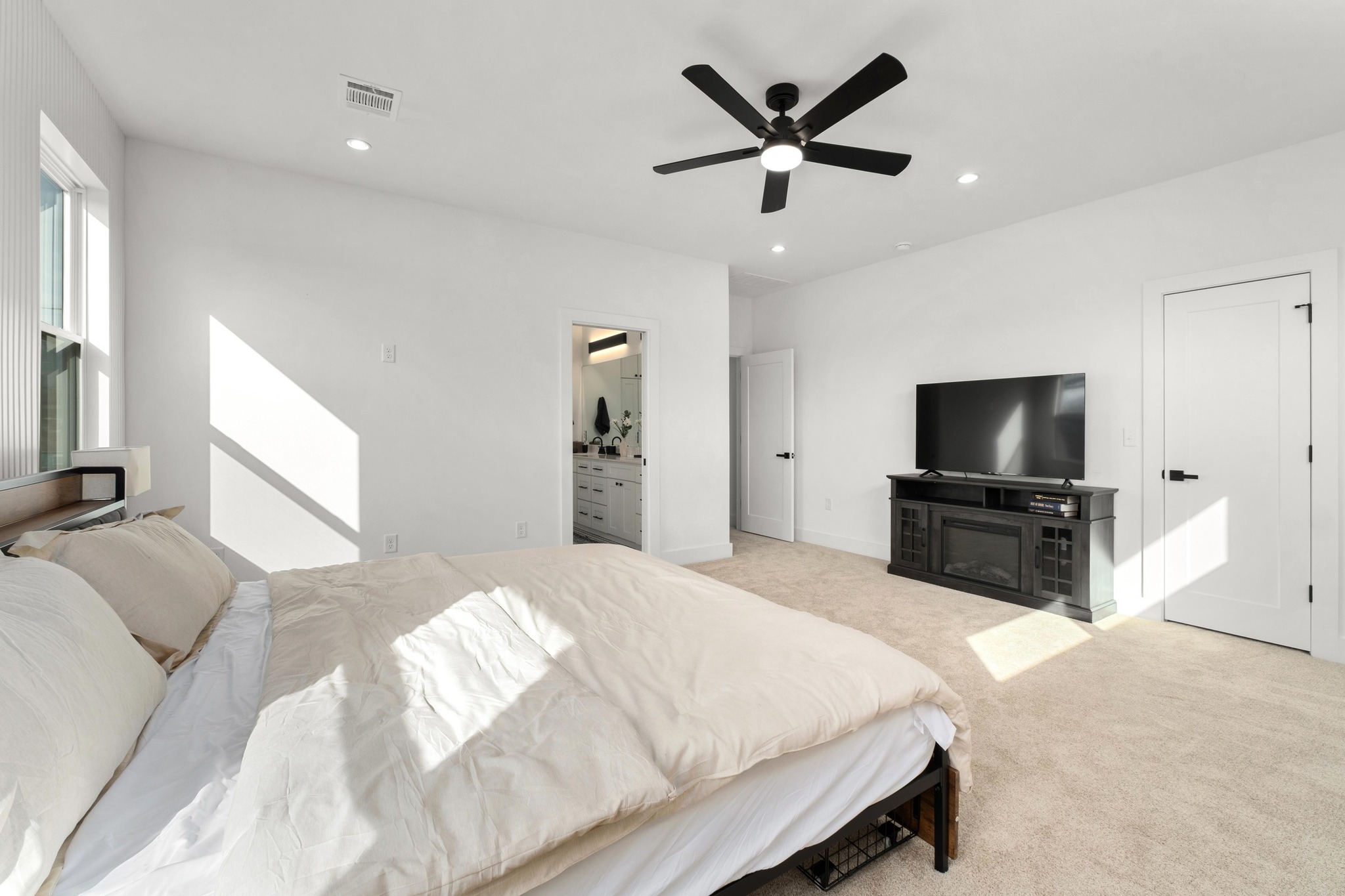 1500 Sylvan Glade, Unit 1B Austin, TX 78745 - Photo 12 of 29 a bedroom with a large bed and a flat screen tv