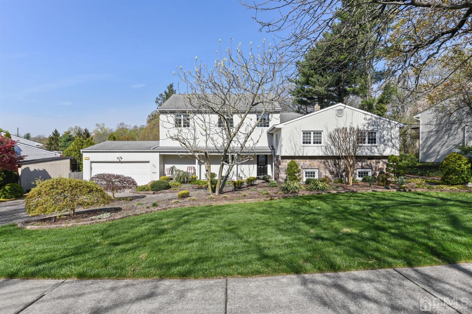 a front view of a house with a yard and a garage