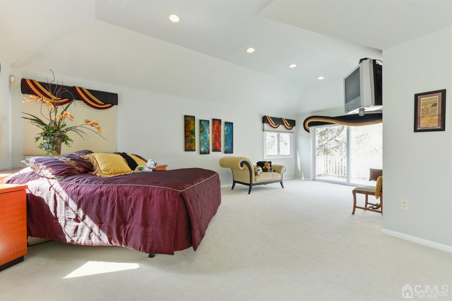 27 Agate Road East Brunswick, NJ 08816 - Photo 15 of 31 a spacious bedroom with a bed a table and painting on the wall