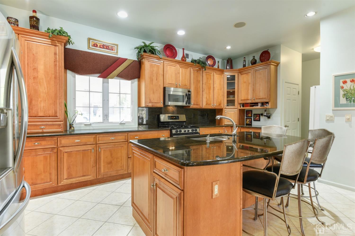 27 Agate Road East Brunswick, NJ 08816 - Photo 6 of 31 a kitchen with stainless steel appliances granite countertop a sink a stove a refrigerator a washer and dryer next to a window