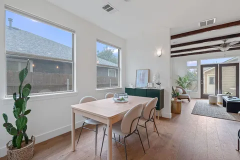 a view of a dining room with furniture window and wooden floor