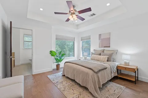 a bedroom with a bed and a chandelier