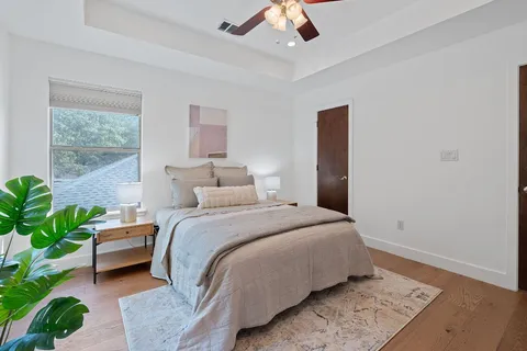 a bedroom with a bed lamp and a potted plant