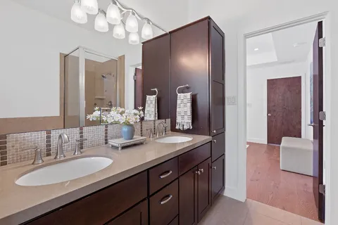 a bathroom with a double vanity sink and a mirror