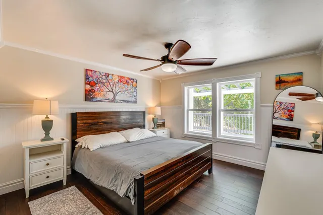 a bedroom with a bed and a large window