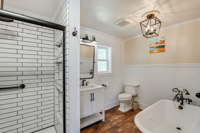 a bathroom with a sink a toilet and shower curtain