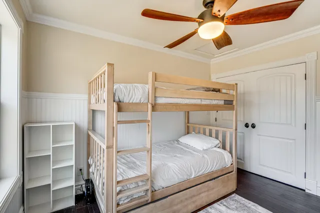 a bedroom with a bed and a ceiling fan
