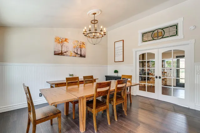a view of a dining room with furniture wooden floor and a chandelier