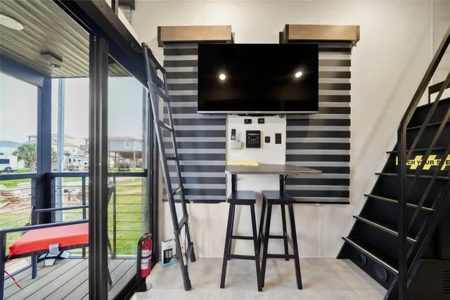 a living room with furniture and a balcony