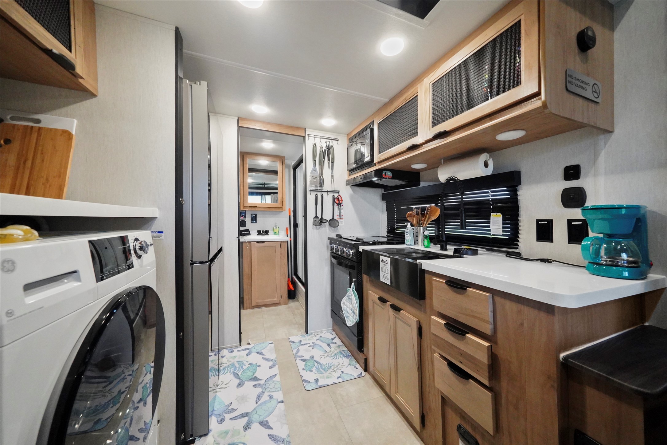 1845 Oleander Crystal Beach, TX 77650 - Photo 15 of 28 a kitchen with refrigerator and cabinets