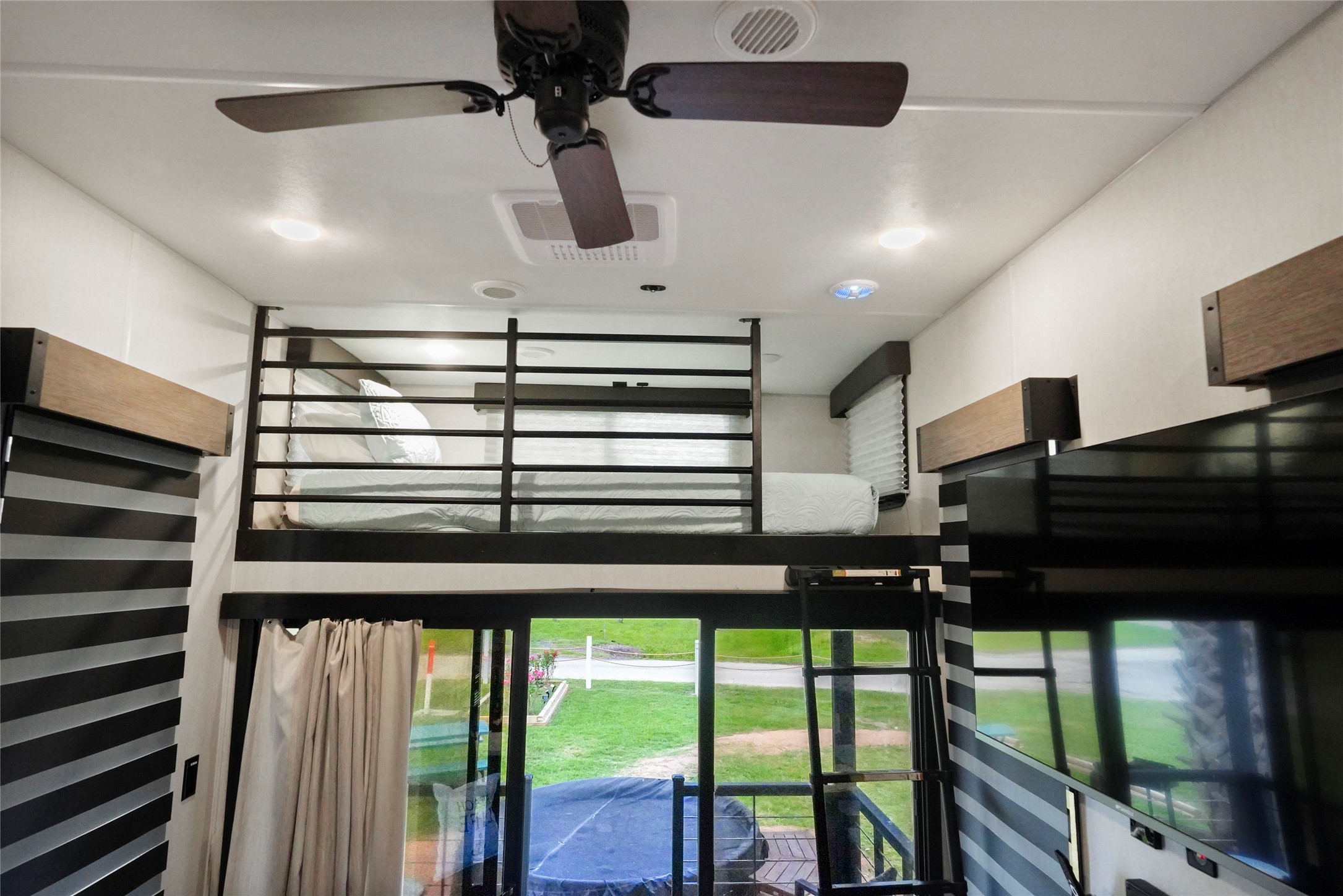 1845 Oleander Crystal Beach, TX 77650 - Photo 24 of 28 a kitchen with a large window and a ceiling fan
