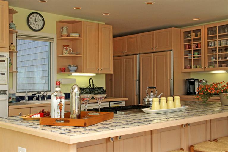 40 Bayshore Lane Eastham, MA 02642 - Photo 11 of 35 a kitchen with kitchen island granite countertop a sink and a stove top oven