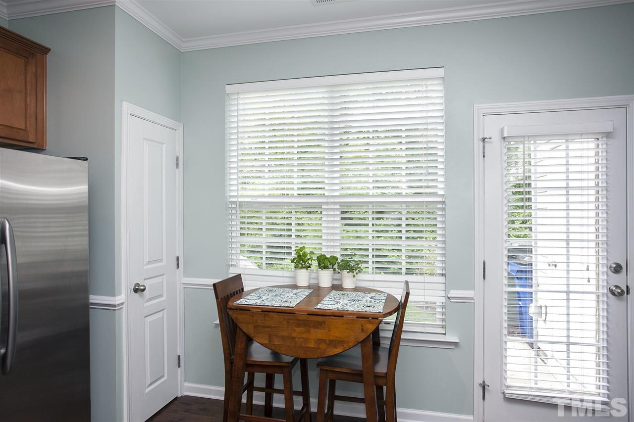 7725 Winners Edge Street Raleigh, NC 27617 - Photo 12 of 25 a view of a dining room with furniture and wooden floor