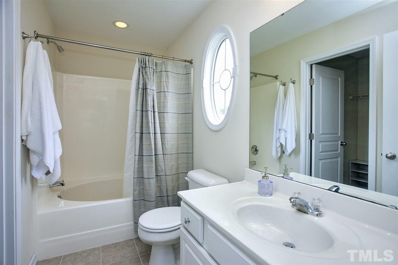 7725 Winners Edge Street Raleigh, NC 27617 - Photo 16 of 25 a bathroom with a sink toilet and shower