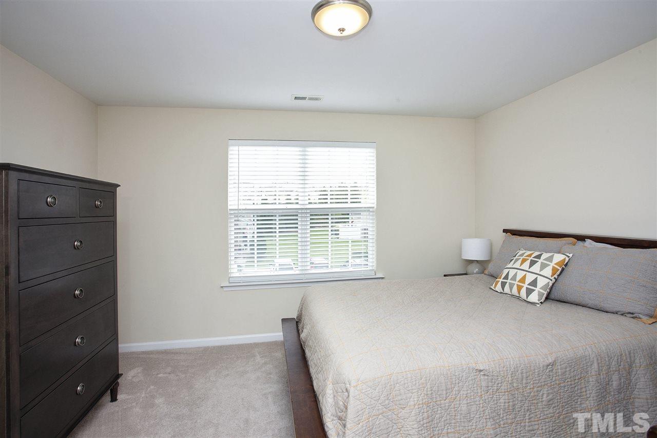 7725 Winners Edge Street Raleigh, NC 27617 - Photo 18 of 25 a bedroom with a bed and a window