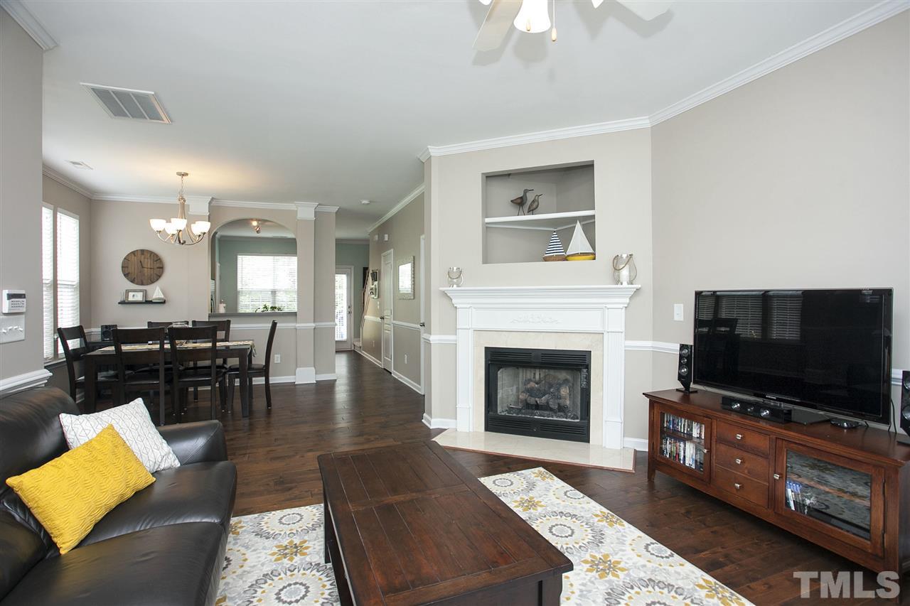 7725 Winners Edge Street Raleigh, NC 27617 - Photo 3 of 25 a living room with furniture a flat screen tv and a fireplace