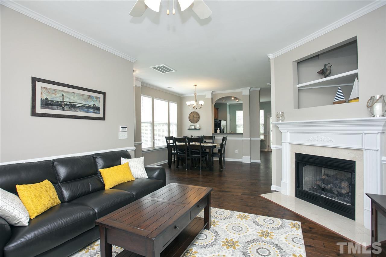 7725 Winners Edge Street Raleigh, NC 27617 - Photo 4 of 25 a living room with furniture and a fireplace