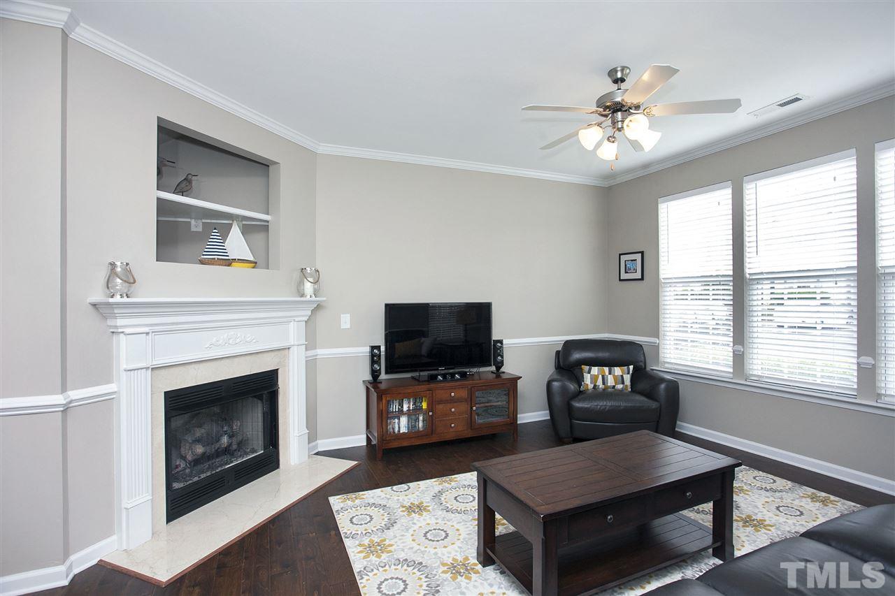 7725 Winners Edge Street Raleigh, NC 27617 - Photo 5 of 25 a living room with furniture and a fireplace