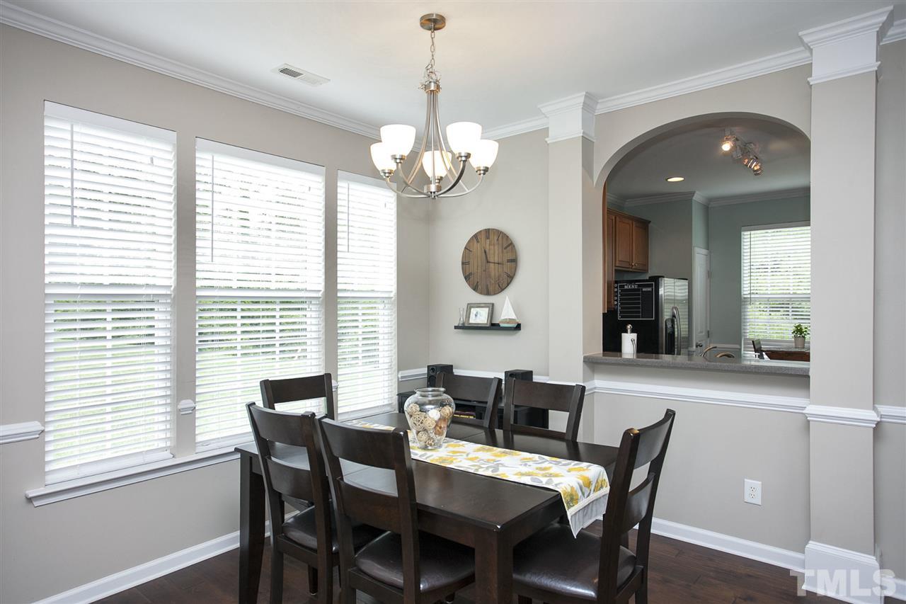7725 Winners Edge Street Raleigh, NC 27617 - Photo 7 of 25 a view of a dining room with furniture and a chandelier