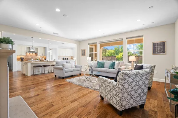 a living room with furniture and large windows