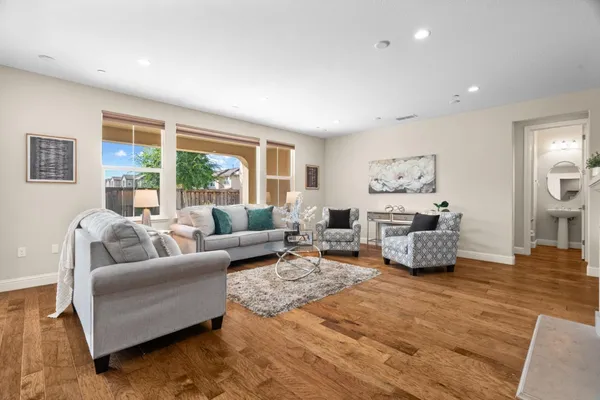 a kitchen with stainless steel appliances granite countertop a sink stove and wooden floor