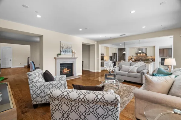 a kitchen with granite countertop stainless steel appliances a refrigerator a sink and cabinets