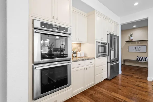 a bedroom with a bed a couch and a wall painting