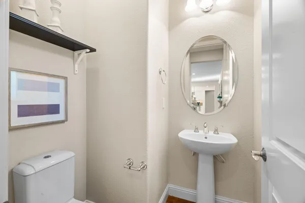 a living room with furniture and painting on the wall