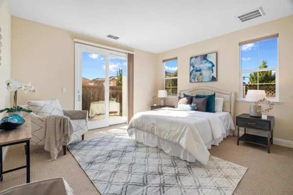 a bedroom with a bed and a chair