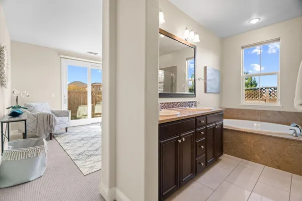 a bathroom with a double vanity sink and a mirror