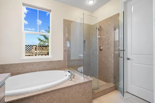 a bathroom with a bathtub and a shower