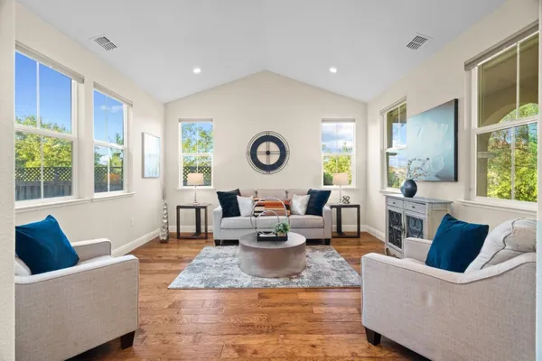 a living room with furniture and a wooden floor