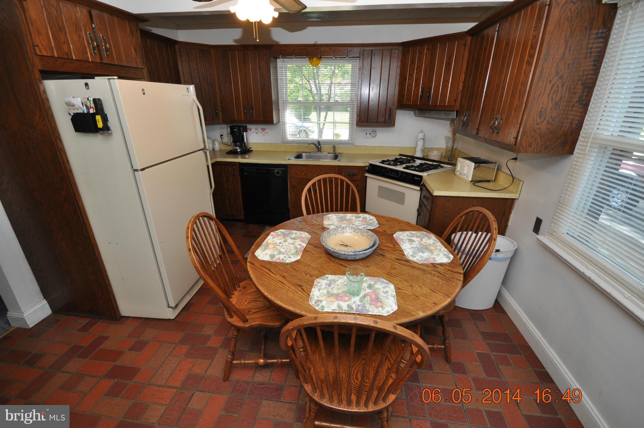 5905 Brookland Road Alexandria, VA 22310 - Photo 14 of 24 a kitchen with granite countertop a sink a stove a refrigerator and a dining table