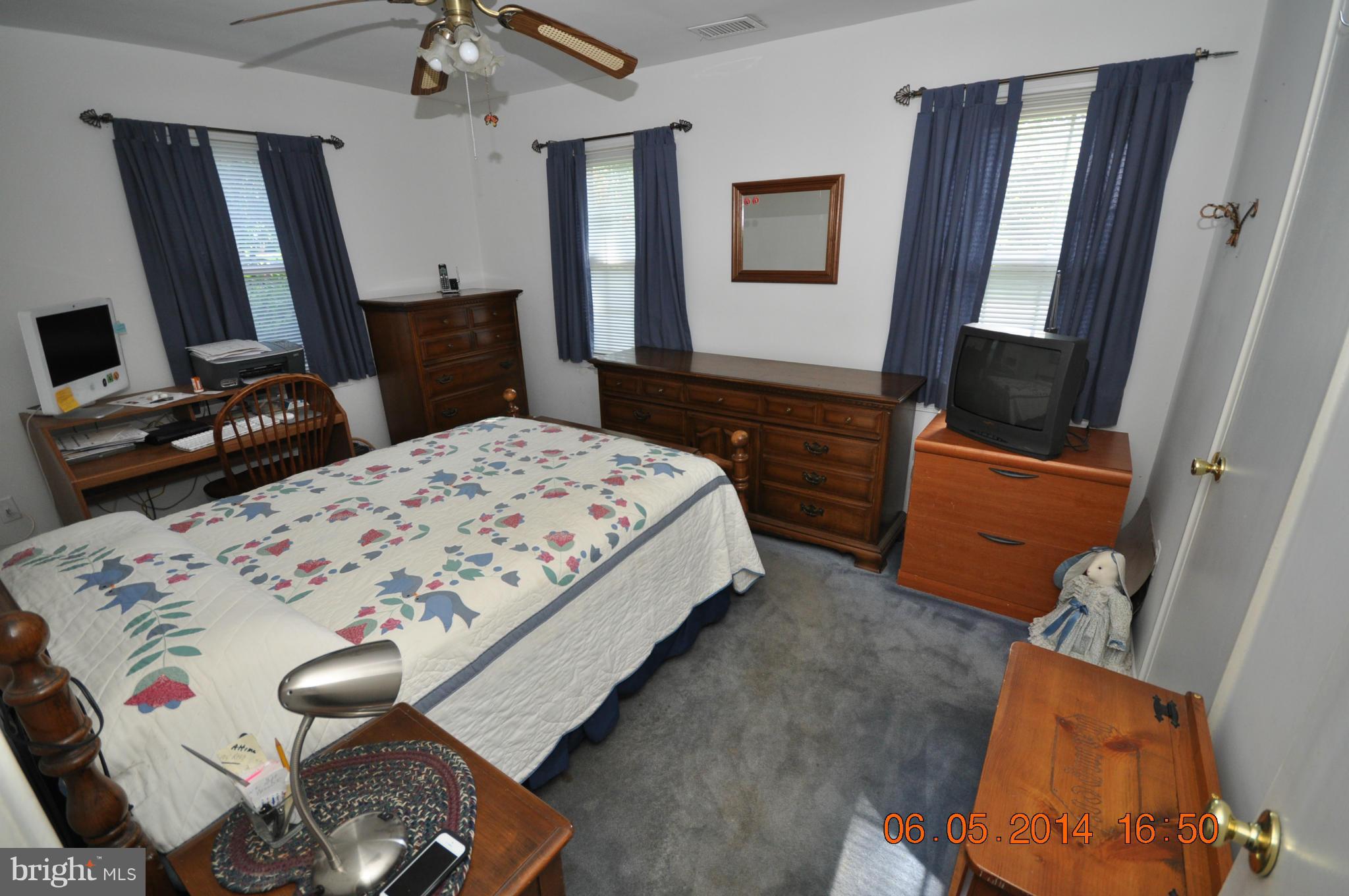 5905 Brookland Road Alexandria, VA 22310 - Photo 21 of 24 a bedroom with a bed and a flat tv screen on dresser