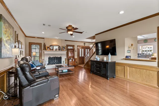 a living room with furniture and a flat screen tv
