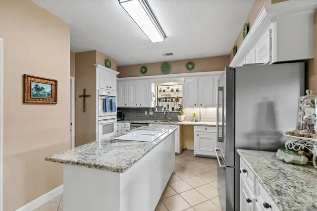 a kitchen with a sink stove and refrigerator