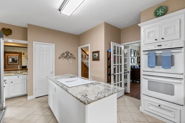 a kitchen with granite countertop cabinets and oven