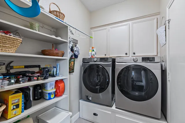 a utility room with sink dryer and washer