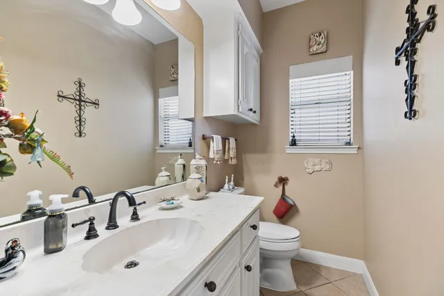 a bathroom with a sink toilet and a mirror