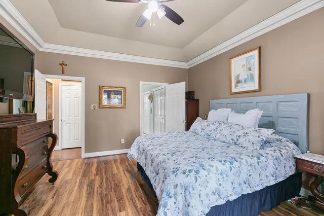 a bedroom with a bed and a chandelier