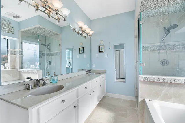 a spacious bathroom with a granite countertop tub sink and mirror
