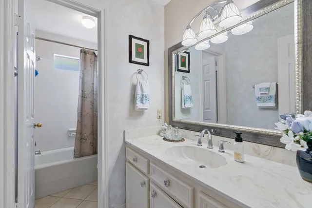 a bathroom with a tub sink and mirror
