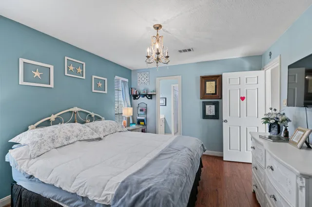 a bedroom with a large bed and a dresser