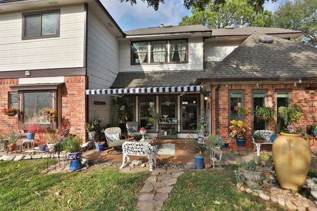 a building outdoor space with patio furniture and potted plants