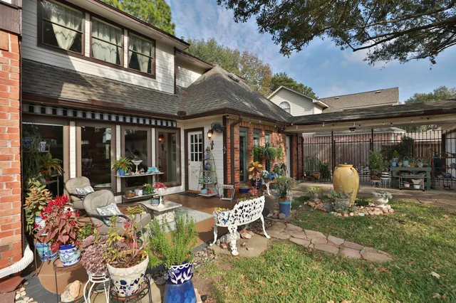 a view of a patio with table and chairs and potted plants