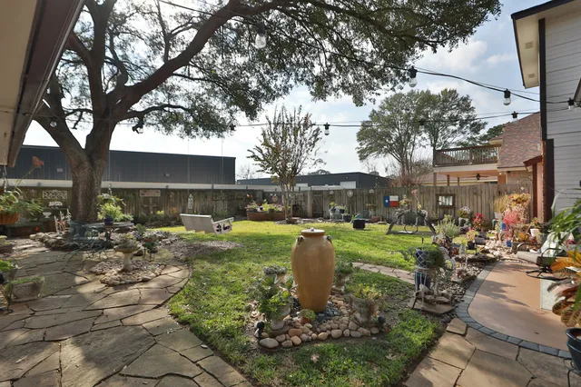 a view of a garden with sitting area