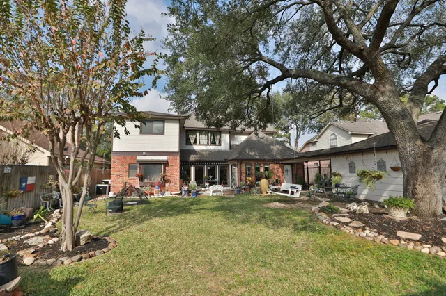 a front view of a house with a yard table and chairs